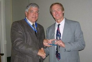In November, Vic Budura (l), chapter president, presents a token of appreciation to Thomas Wright, G-2/Army Southeast account manager, NetApp.